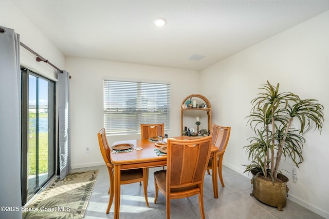 tiled dining space with a healthy amount of sunlight