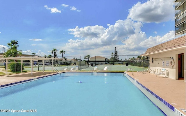 view of pool with tennis court