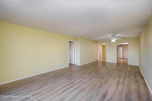 spare room featuring ceiling fan and light hardwood / wood-style floors