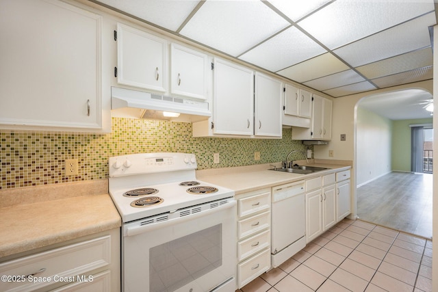 kitchen with white cabinetry, sink, white appliances, and decorative backsplash