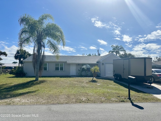 single story home featuring a garage and a front lawn