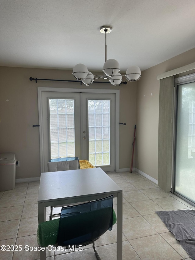 dining space with light tile patterned floors and french doors