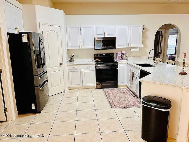 kitchen featuring white cabinetry, sink, black appliances, and kitchen peninsula