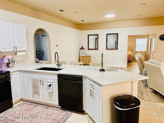 kitchen with white cabinetry, kitchen peninsula, sink, and light tile patterned floors