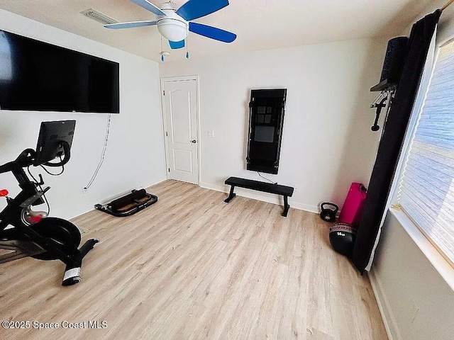 exercise area with light hardwood / wood-style floors and ceiling fan