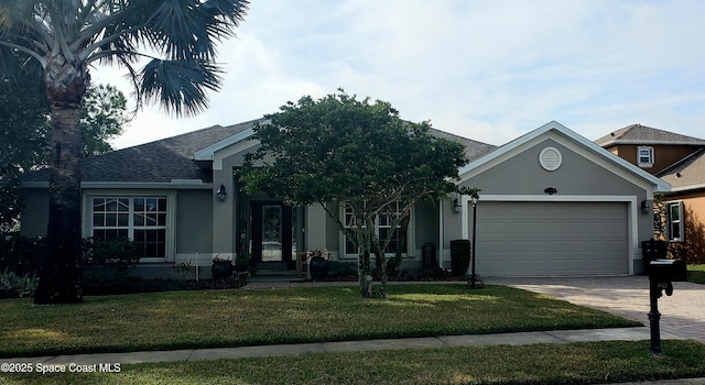 view of front facade with a garage and a front lawn