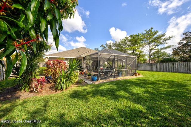 view of yard featuring glass enclosure