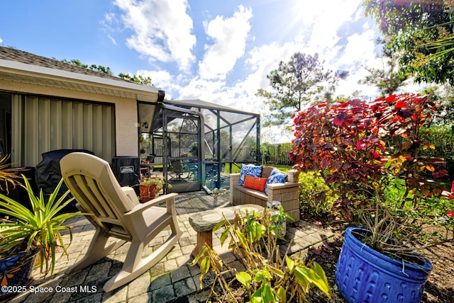 view of patio / terrace featuring glass enclosure