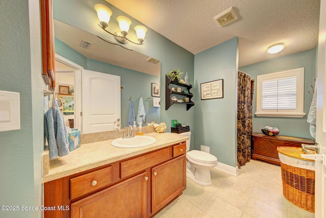 bathroom featuring vanity, tile patterned floors, a textured ceiling, and toilet