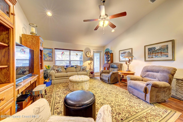 living room featuring vaulted ceiling, wood-type flooring, and ceiling fan