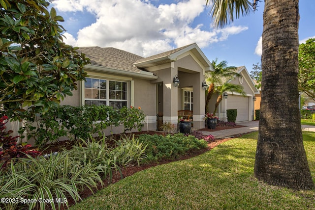 view of front of house featuring a garage and a front lawn