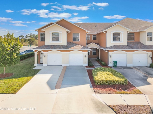 view of front of property with a garage and a front lawn