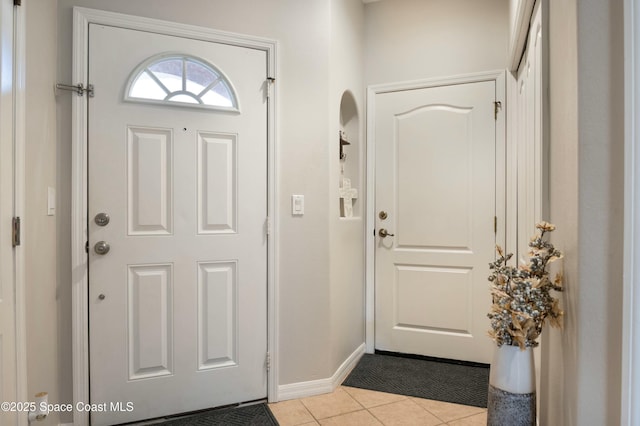 foyer entrance with light tile patterned flooring