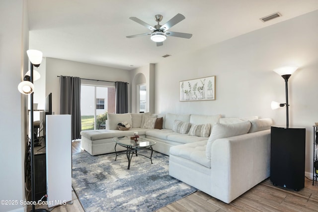 living room with hardwood / wood-style flooring and ceiling fan