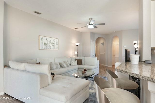 living room featuring ceiling fan and hardwood / wood-style floors