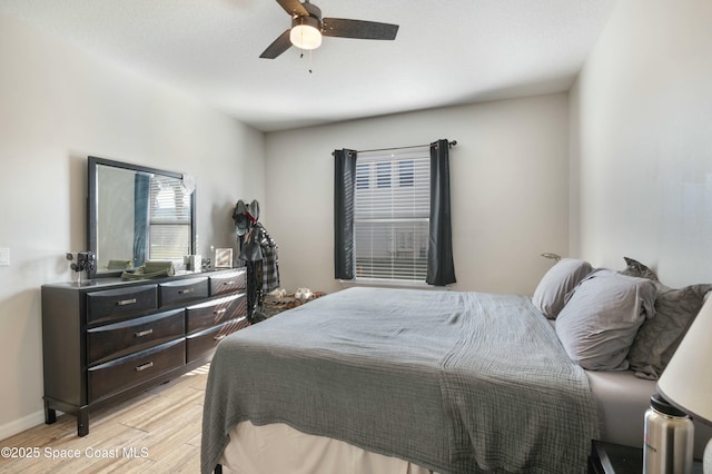 bedroom with ceiling fan and light wood-type flooring