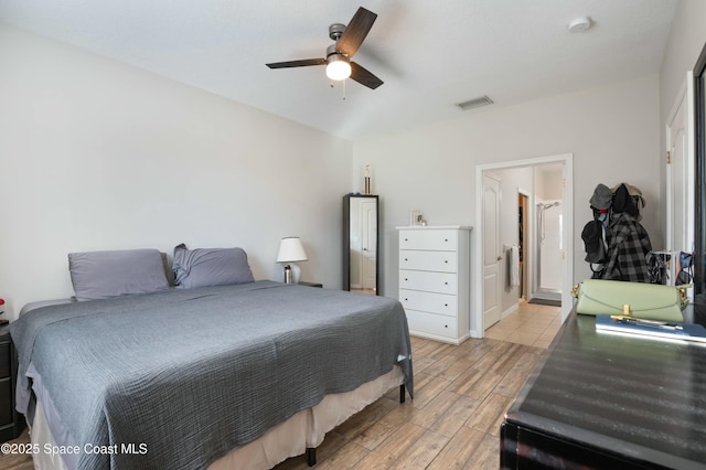 bedroom featuring ceiling fan, ensuite bathroom, and light hardwood / wood-style floors