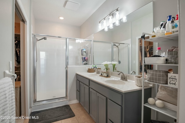 bathroom featuring tile patterned flooring, vanity, and a shower with shower door