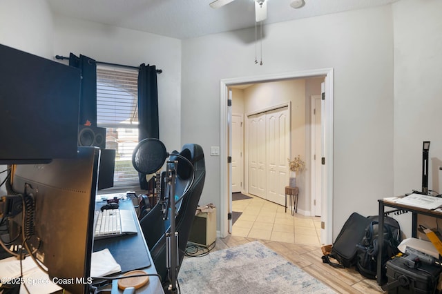 home office featuring light hardwood / wood-style flooring and ceiling fan