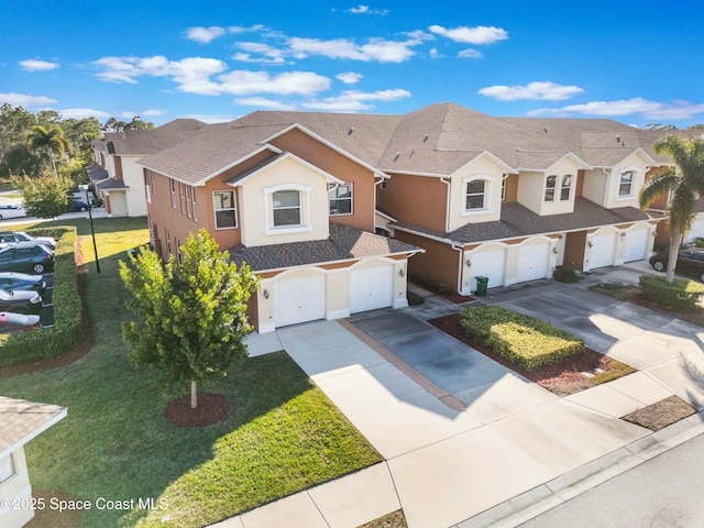 view of front of home featuring a garage and a front lawn