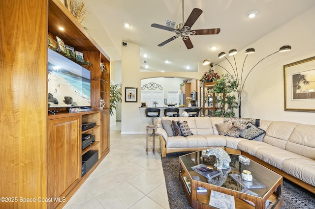 tiled living room with ceiling fan