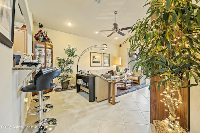 living room with light tile patterned flooring and ceiling fan