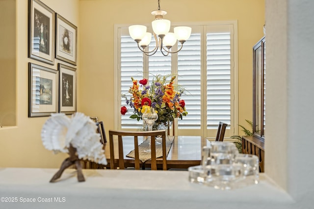 dining space featuring a wealth of natural light and a chandelier