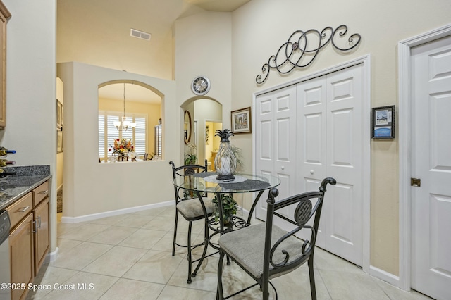 tiled dining room featuring a chandelier