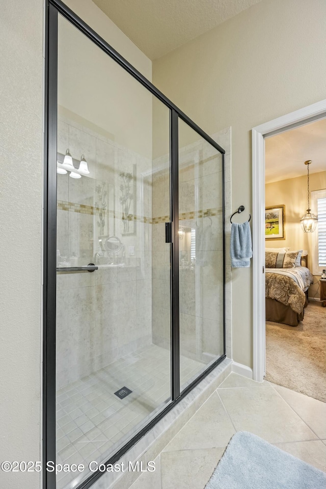 bathroom with tile patterned flooring, an enclosed shower, and a textured ceiling