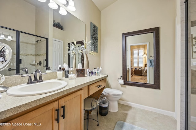 bathroom featuring vanity, tile patterned floors, toilet, and walk in shower