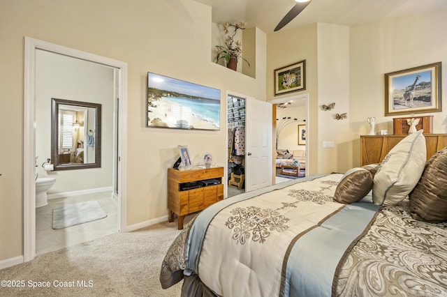 bedroom featuring connected bathroom, ceiling fan, and carpet