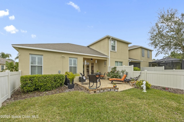 back of property with a patio and a lawn