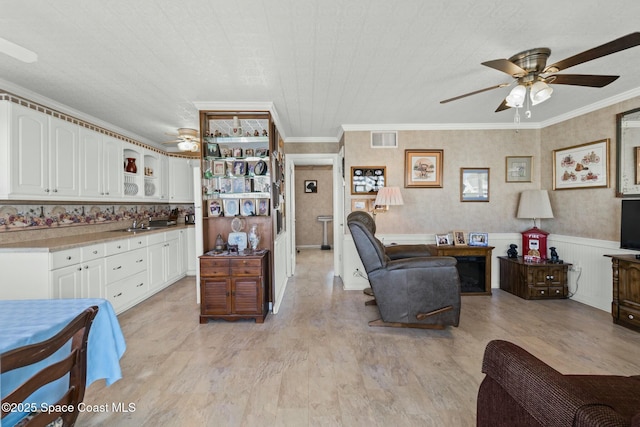 interior space with crown molding, white cabinets, and light hardwood / wood-style flooring