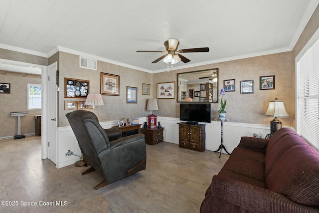 living room featuring ceiling fan and ornamental molding