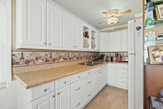 kitchen featuring sink, crown molding, and white cabinets