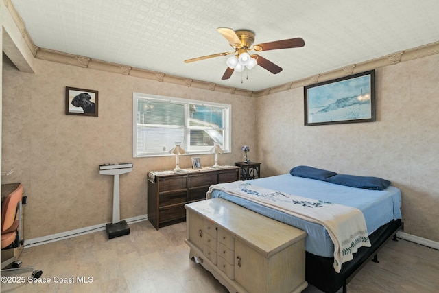 bedroom featuring ceiling fan, ornamental molding, and light wood-type flooring