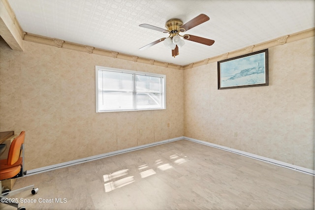 empty room featuring wood finished floors, ceiling fan, and baseboards