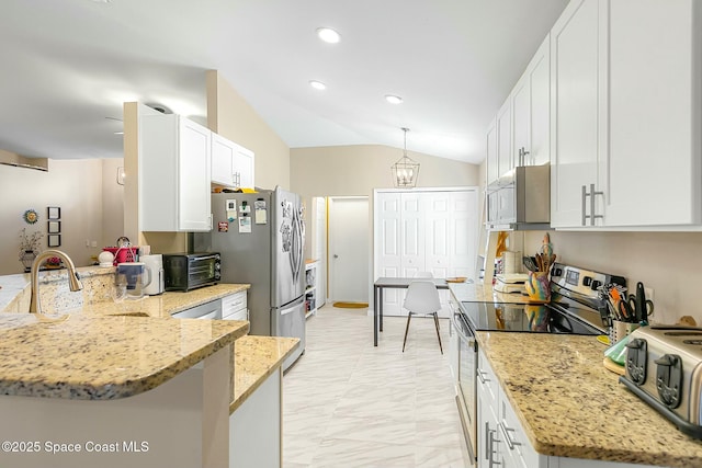 kitchen with stainless steel appliances, pendant lighting, white cabinets, and kitchen peninsula