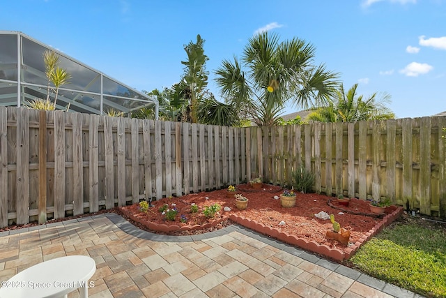 view of patio / terrace featuring a lanai