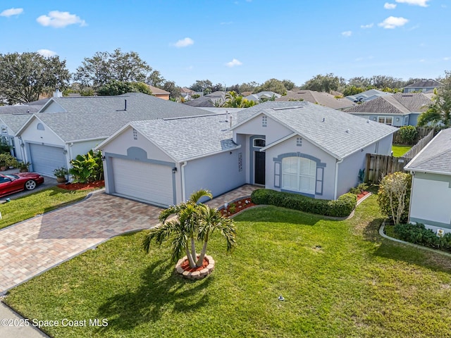 single story home featuring a garage and a front yard