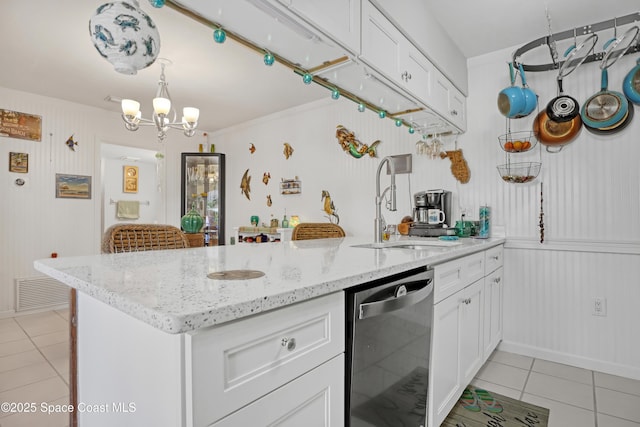 kitchen featuring white cabinetry, dishwasher, sink, light tile patterned floors, and kitchen peninsula