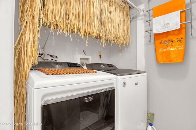 clothes washing area with washer and clothes dryer