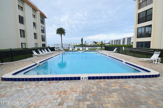 view of swimming pool with a patio