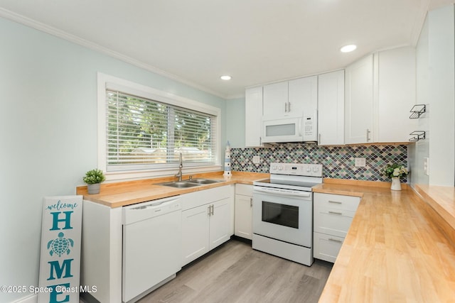 kitchen featuring sink, white appliances, wooden counters, and white cabinets