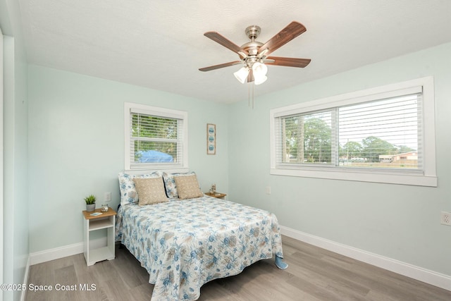 bedroom with hardwood / wood-style floors and ceiling fan