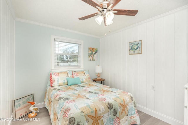 bedroom with ceiling fan, ornamental molding, and light wood-type flooring