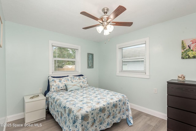 bedroom with light hardwood / wood-style floors and ceiling fan