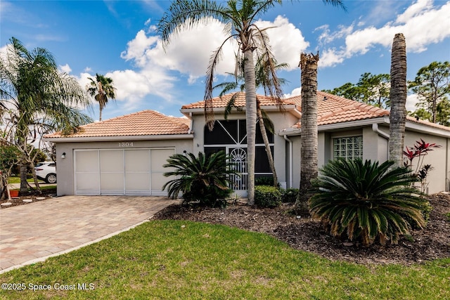 mediterranean / spanish home with a garage