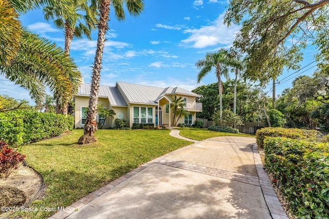 ranch-style home featuring a front yard and a balcony