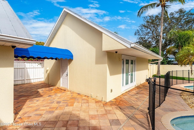 rear view of property featuring a patio and french doors